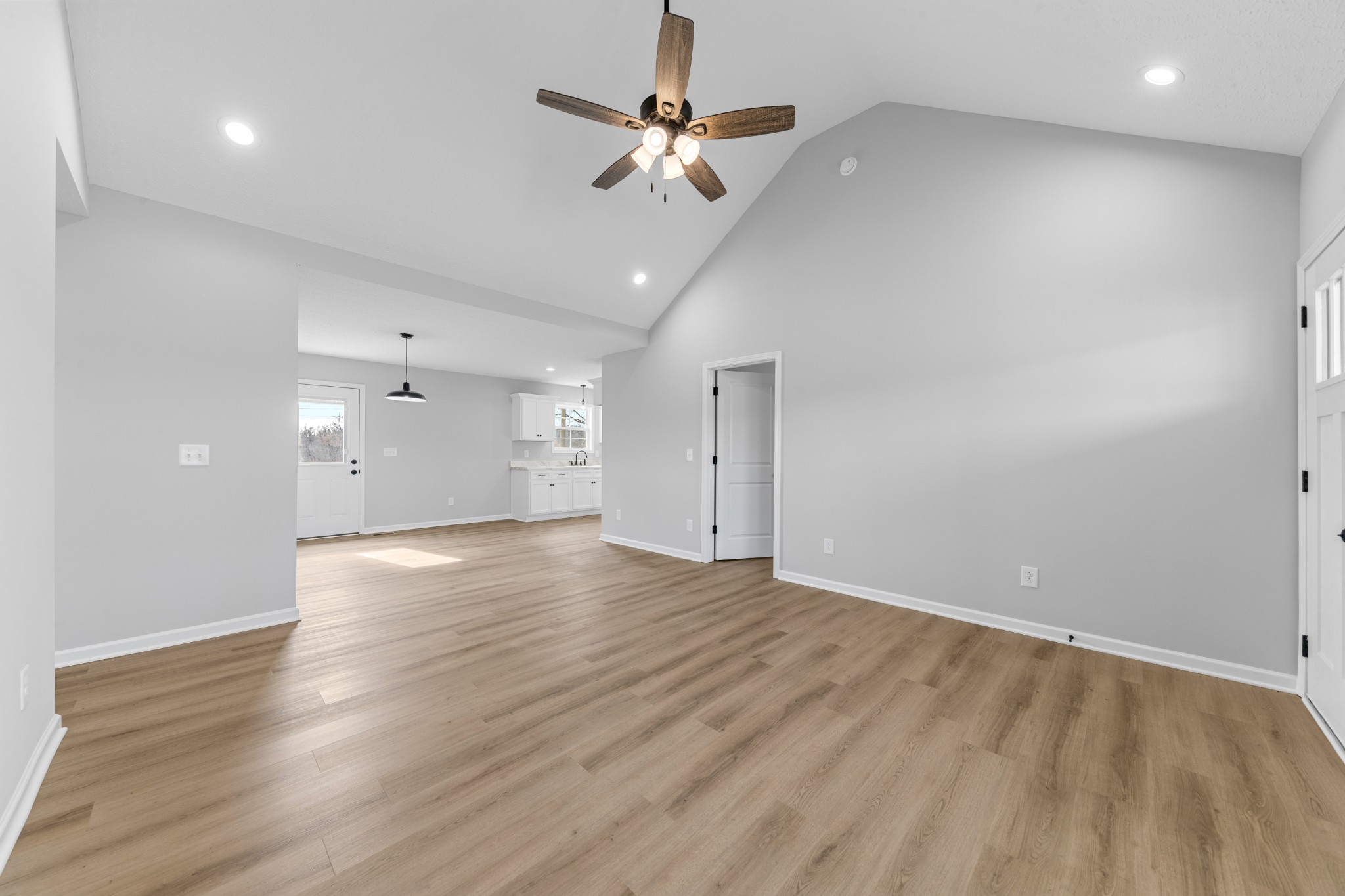 7 Orchard Cemetery Road Petersburg, TN 37144 - Photo 24 of 53 an empty room with wooden floor chandelier fan and windows