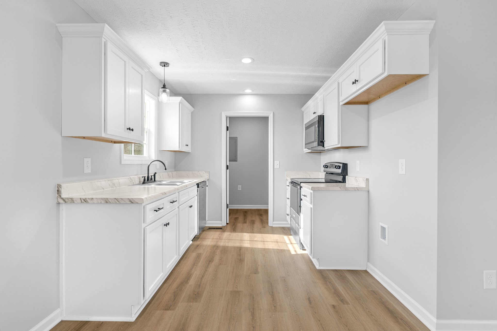 7 Orchard Cemetery Road Petersburg, TN 37144 - Photo 34 of 53 a large kitchen with kitchen island a sink a stove a refrigerator and white cabinets