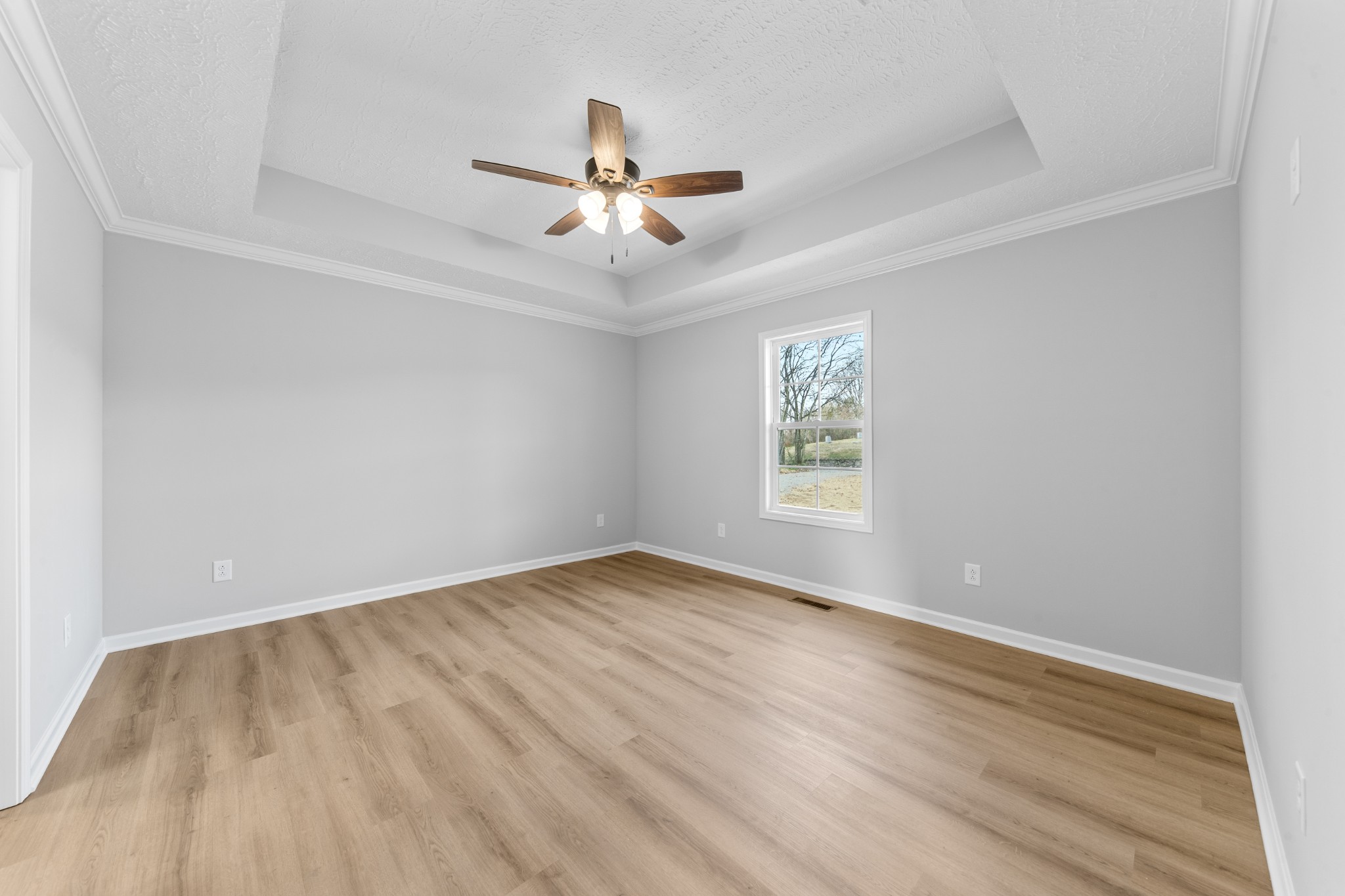 7 Orchard Cemetery Road Petersburg, TN 37144 - Photo 41 of 53 an empty room with wooden floor ceiling fan and windows
