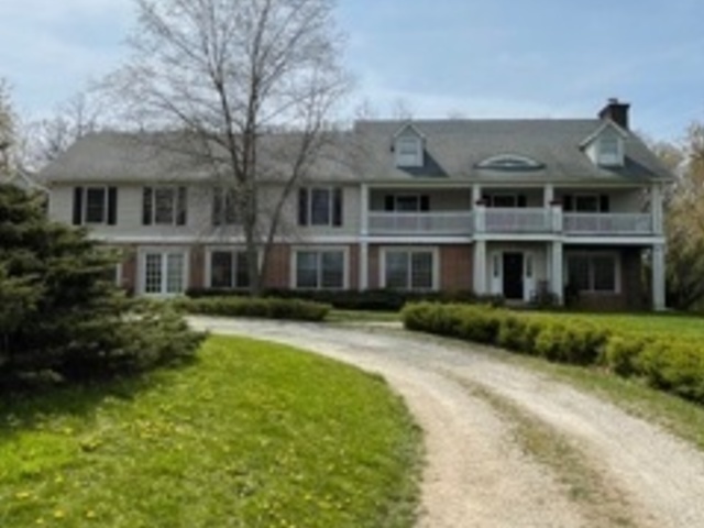 a front view of a building with a garden