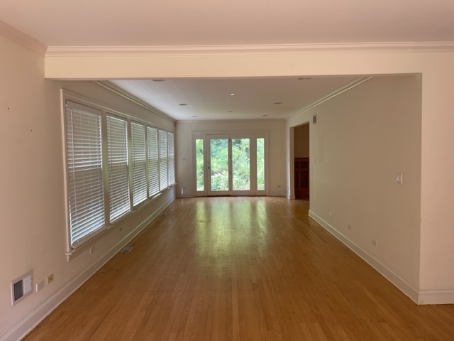 205 Oakdene Drive Barrington, IL 60010 - Photo 3 of 10 a view of an empty room with wooden floor and a window