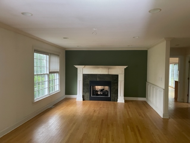 205 Oakdene Drive Barrington, IL 60010 - Photo 5 of 10 an empty room with wooden floor fire place and windows