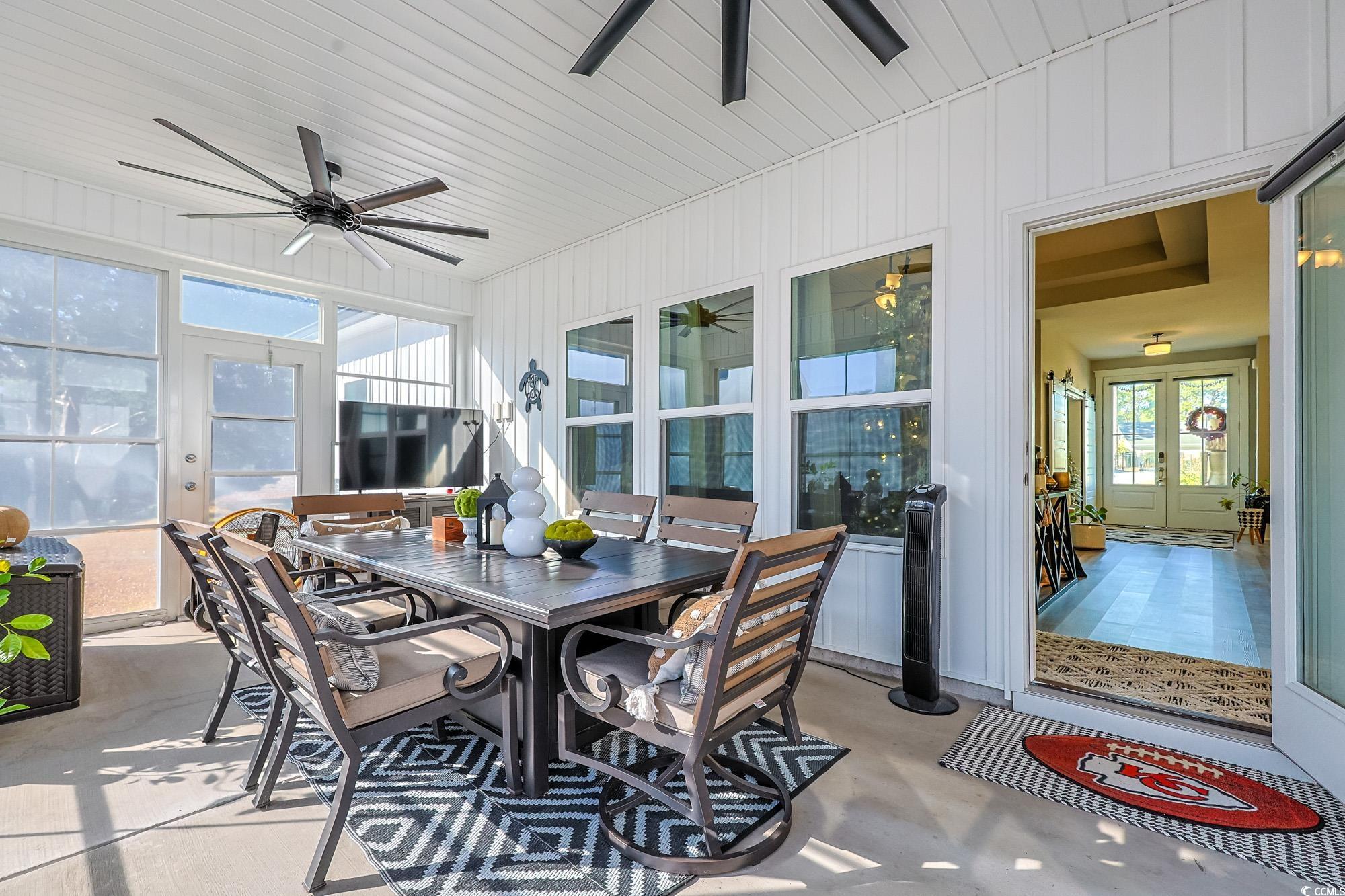 669 Pacific Commons Drive Surfside Beach, SC 29575 - Photo 15 of 36 Sunroom with outdoor dining area, a ceiling fan, french doors, and a patio area