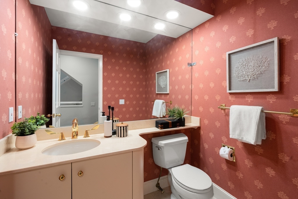 214 Allandale Road, Unit B Boston, MA 02467 - Photo 14 of 35 a bathroom with a toilet a sink and mirror