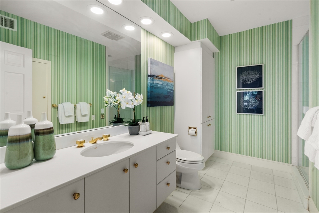 214 Allandale Road, Unit B Boston, MA 02467 - Photo 17 of 35 a bathroom with a double vanity sink toilet and shower