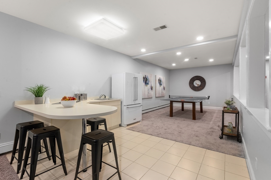214 Allandale Road, Unit B Boston, MA 02467 - Photo 21 of 35 a living room with furniture and a table