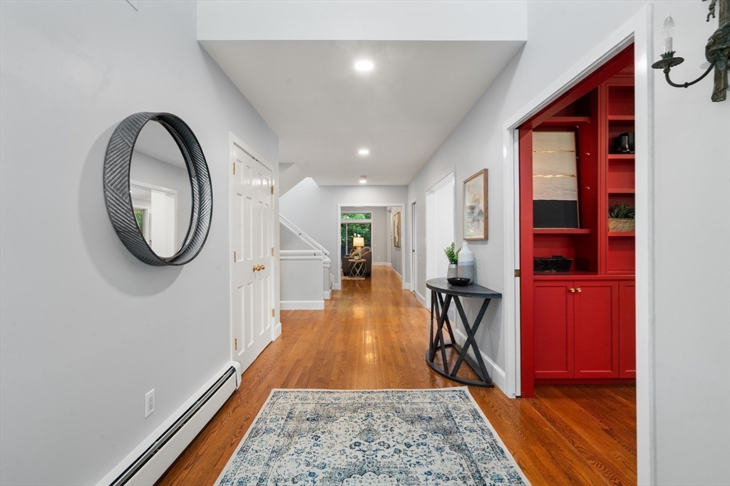 214 Allandale Road, Unit B Boston, MA 02467 - Photo 4 of 35 a view of a hallway with wooden floor and a bathroom