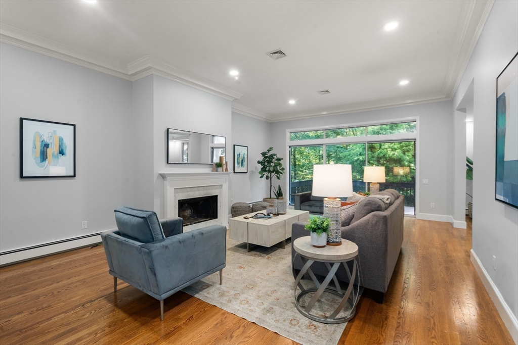 214 Allandale Road, Unit B Boston, MA 02467 - Photo 7 of 35 a living room with fireplace furniture and a wooden floor