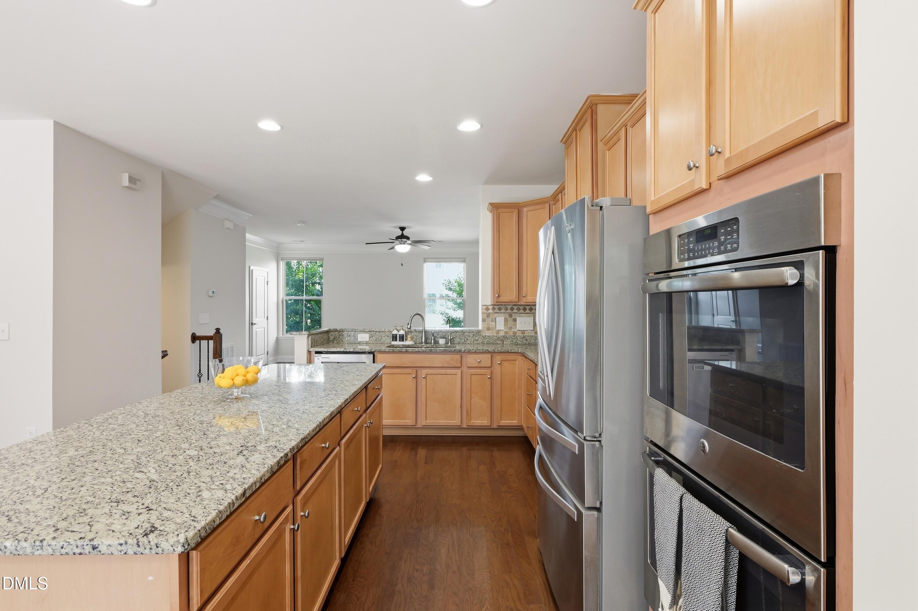 1004 Waymaker Court Apex, NC 27502 - Photo 8 of 30 a kitchen with stainless steel appliances granite countertop a refrigerator and a sink