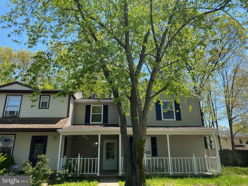 65 Berkshire Road Sicklerville, NJ 08081 - Photo 1 of 29 a view of a white house with large windows and a large tree