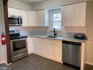 65 Berkshire Road Sicklerville, NJ 08081 - Photo 3 of 29 a kitchen with granite countertop white cabinets and appliances
