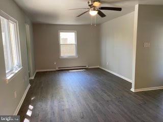 65 Berkshire Road Sicklerville, NJ 08081 - Photo 7 of 29 an empty room with wooden floor fan and windows