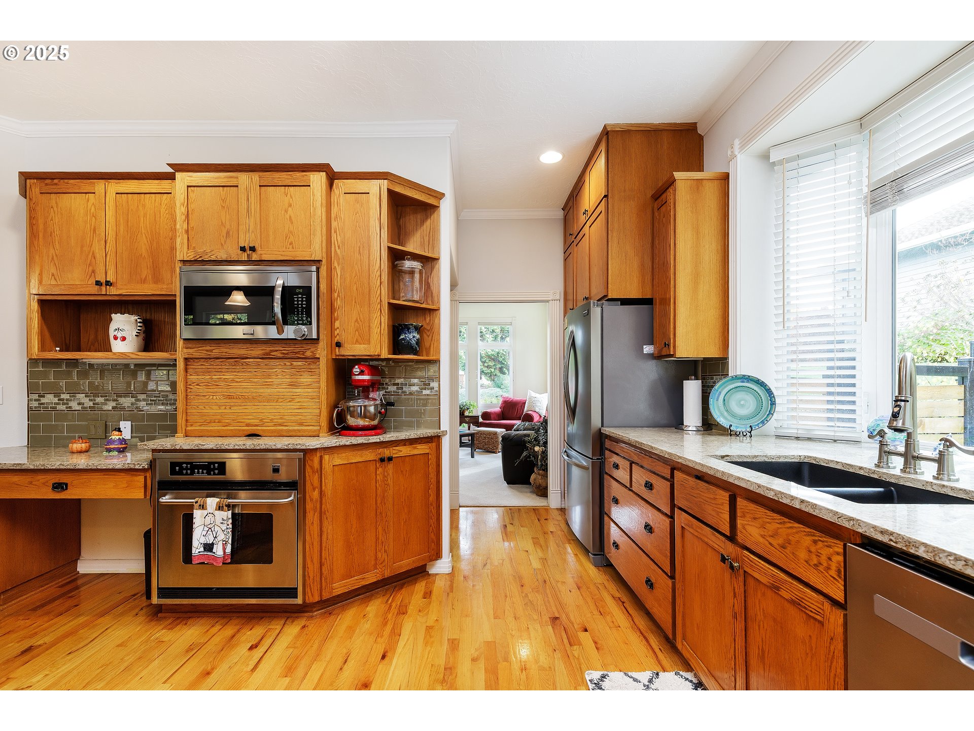 2573 Southeast Morlan Way Gresham, OR 97080 - Photo 12 of 47 a kitchen with stainless steel appliances granite countertop a stove a sink and a microwave