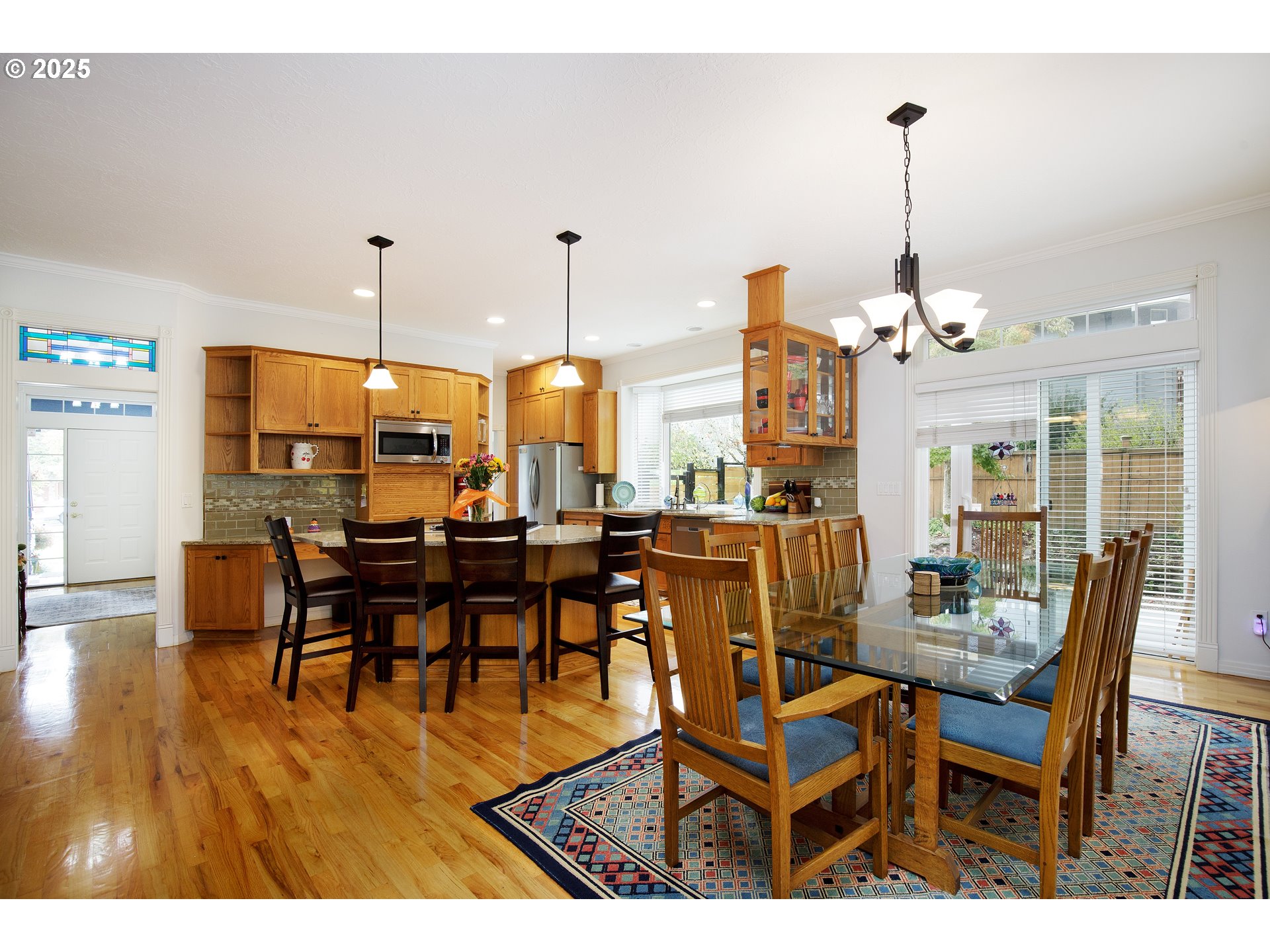 2573 Southeast Morlan Way Gresham, OR 97080 - Photo 18 of 47 a view of a dining room and livingroom with furniture wooden floor a chandelier
