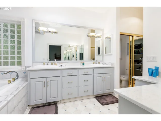 a en suite bathroom with a sink and a large mirror