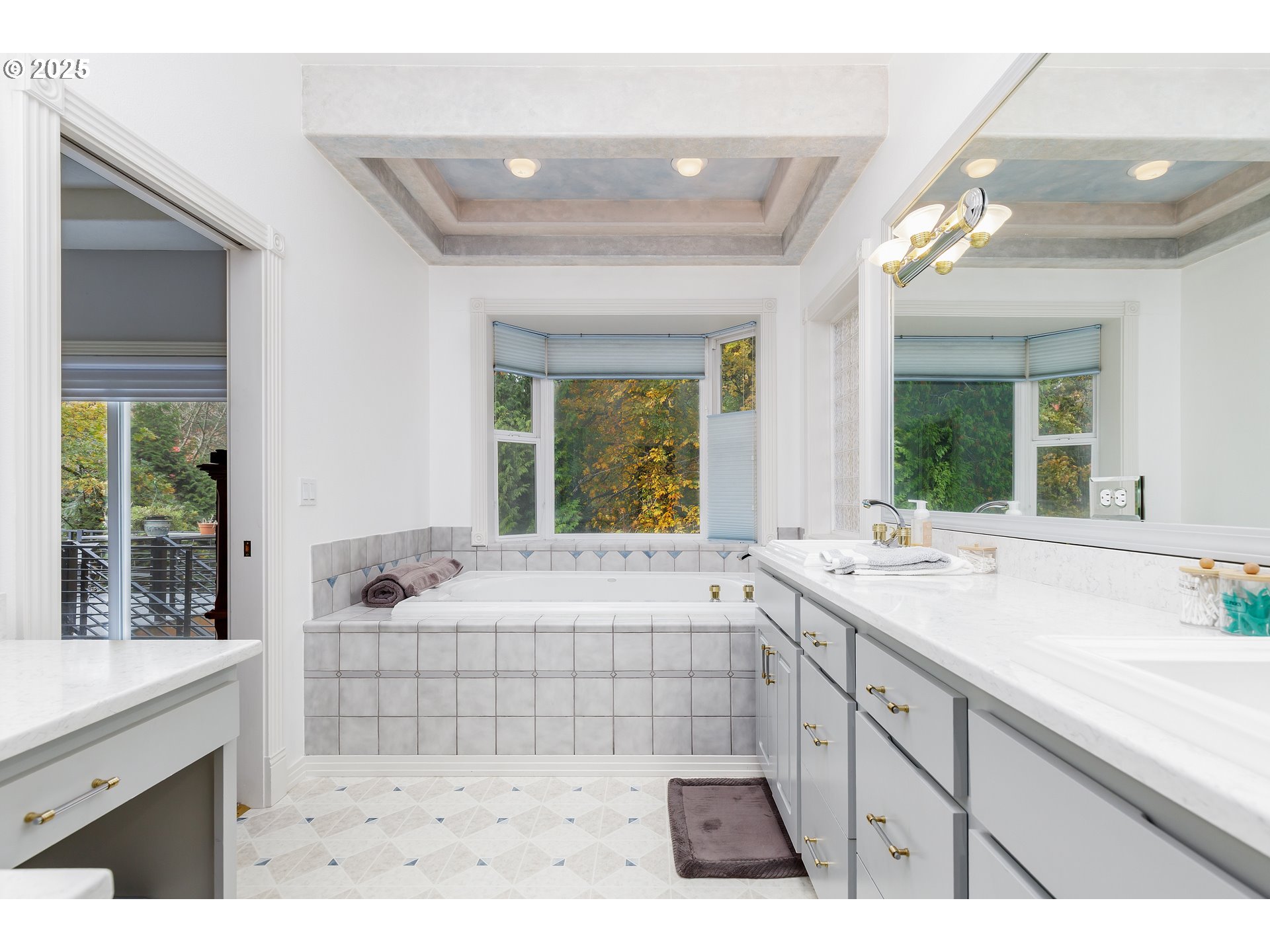 2573 Southeast Morlan Way Gresham, OR 97080 - Photo 32 of 47 a spacious bathroom with a sink a large mirror a bathtub and next to a window