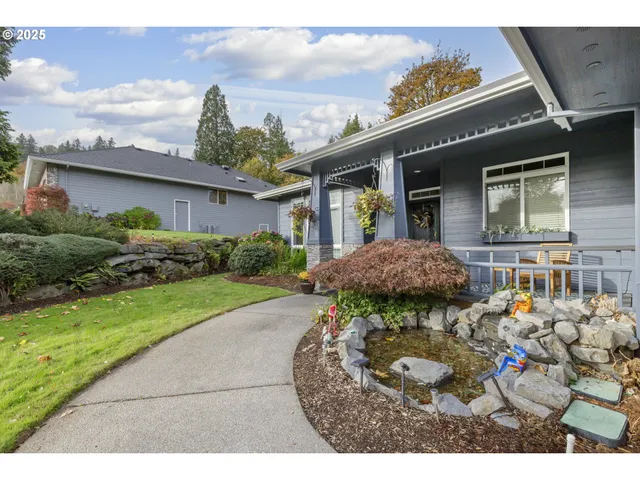 a backyard of a house with table and chairs
