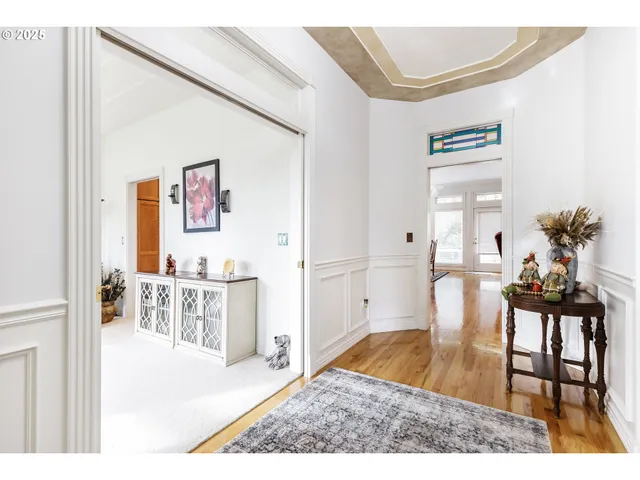 a living room with furniture and a dining table