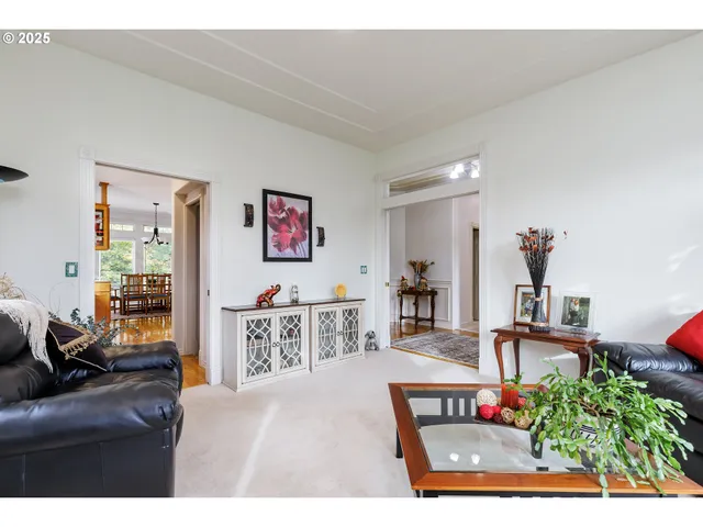 a living room with furniture and flowers