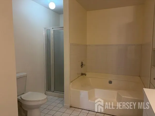 a white bath tub sitting next to a toilet