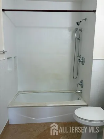 a bathroom with a shower and a toilet