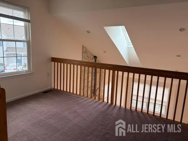 a view of a hall with wooden floor