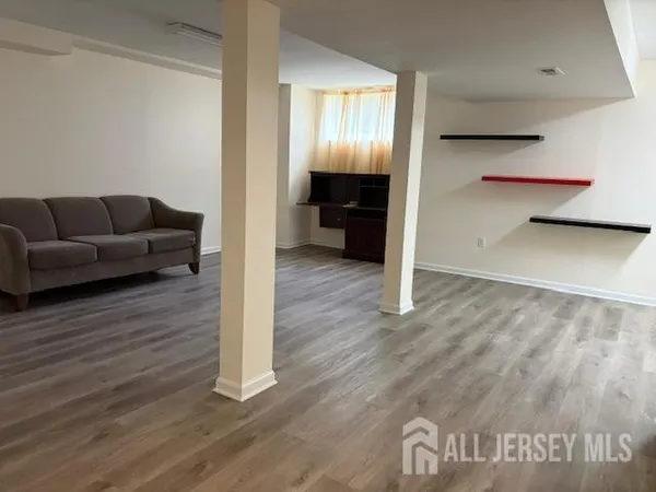 a living room with furniture and a walk in closet