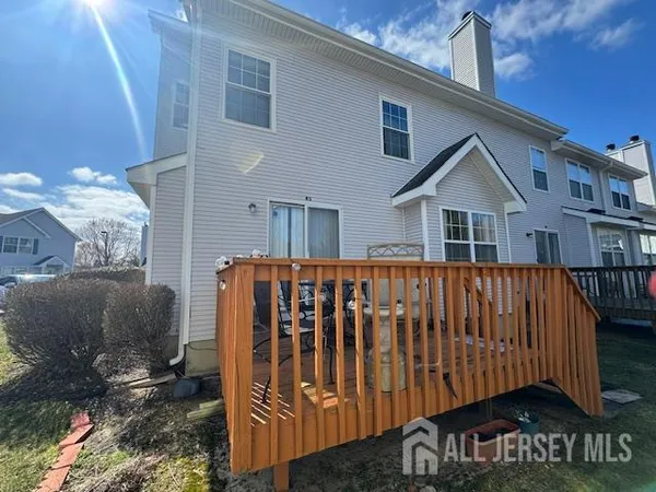 a view of a house with a wooden deck