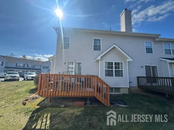 a view of a house with a yard and deck