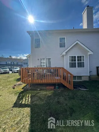 a view of a house with a yard and deck