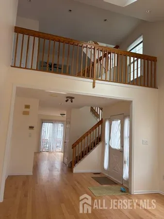 a view of entryway with stairs and wooden floor