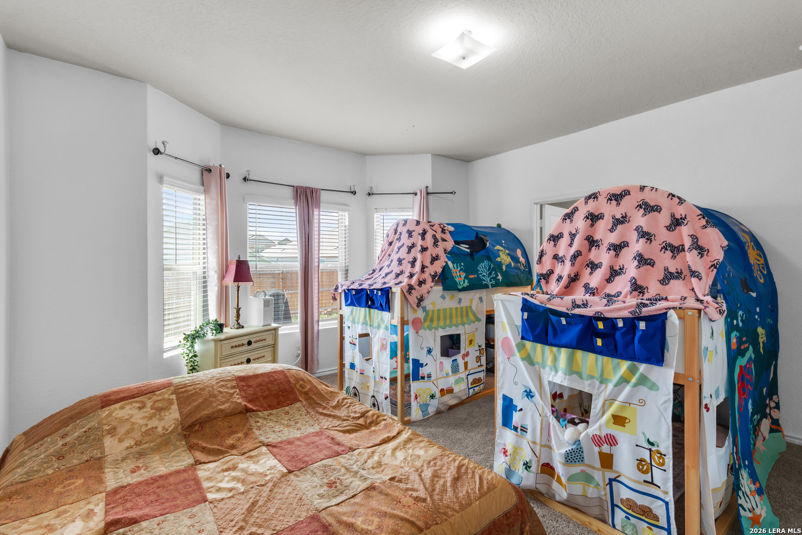 5919 Poolside Park Converse, TX 78109 - Photo 18 of 25 a bedroom with a bed a window and walk in closet