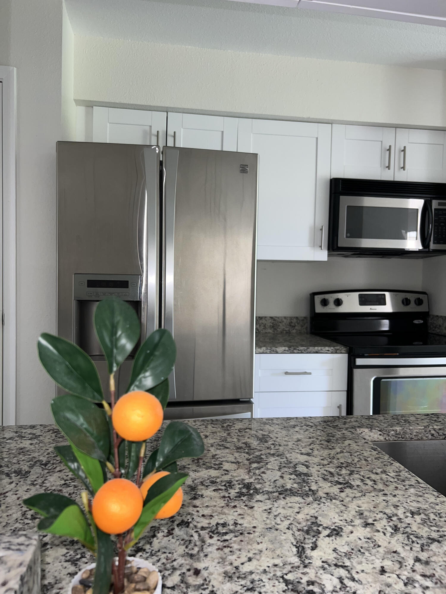 899 Riverside Drive, Unit 620 Coral Springs, FL 33071 - Photo 8 of 46 a kitchen with a stove a refrigerator and a fireplace