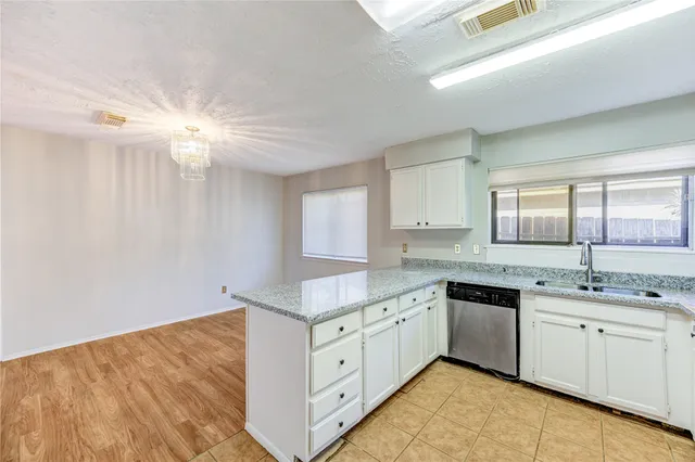 a kitchen with a sink cabinets and window