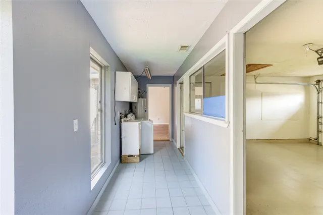 a view of a kitchen with fridge and outdoor view