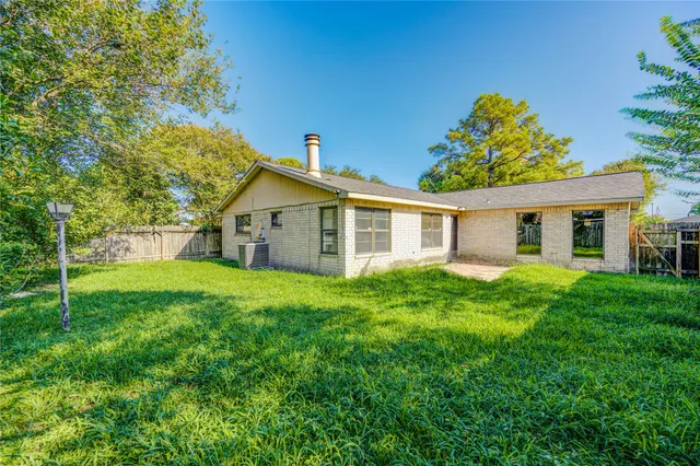 a view of a house with pool and a yard