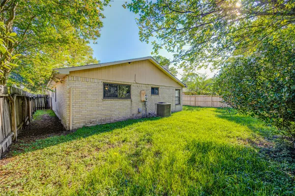 a front view of a house with a garden and yard