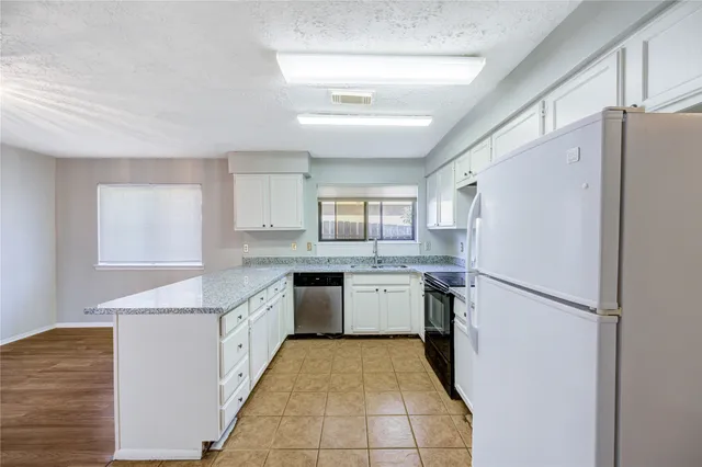 a kitchen with a refrigerator a sink and dishwasher