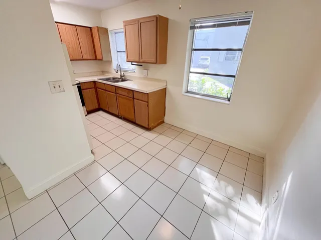 a kitchen with stainless steel appliances a refrigerator and a stove top oven