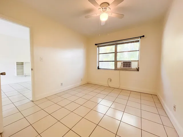 a view of an empty room and a window