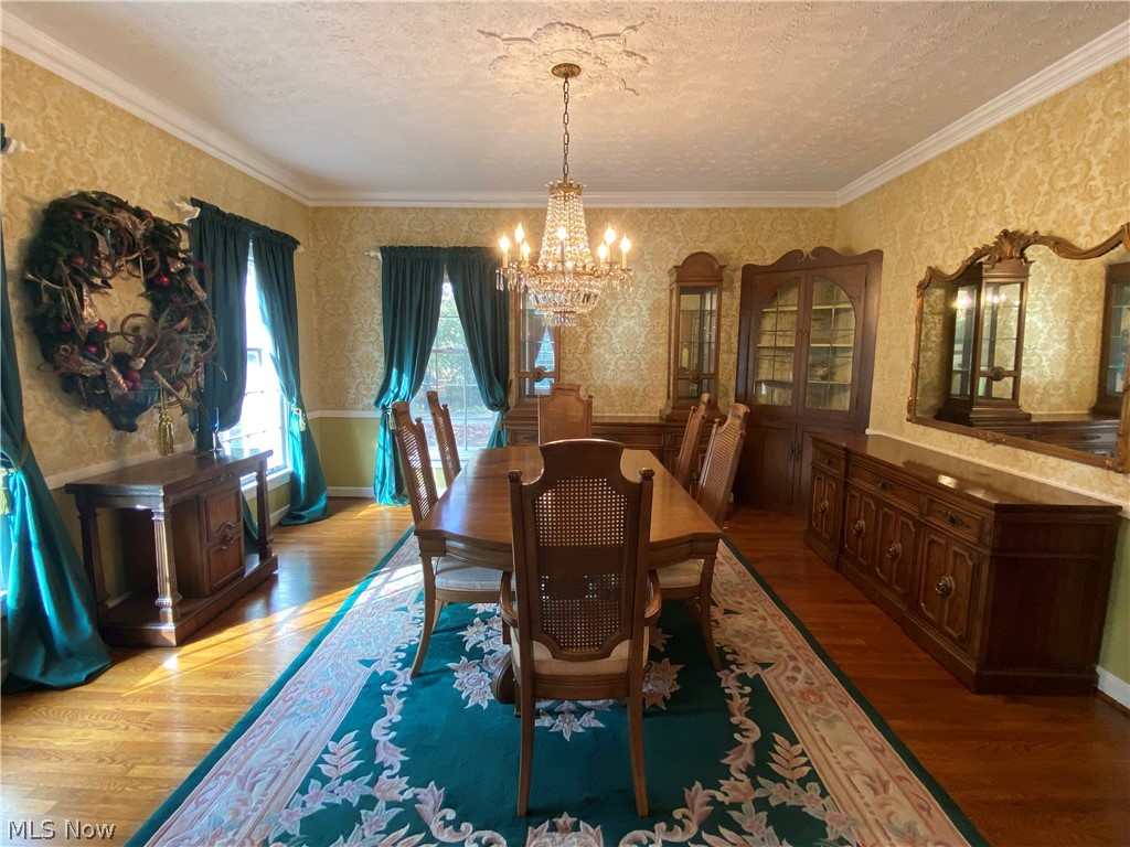1387 Clearview Road Cleveland, OH 44124 - Photo 7 of 33 Formal dining room with incredible crown molding and ceiling medallion highlighted by stunning chandelier, perfect for hosting large dinner parties.