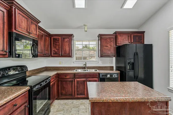 a kitchen with a sink stove and refrigerator