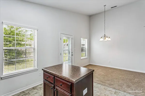 a kitchen with kitchen island a counter top space and a window