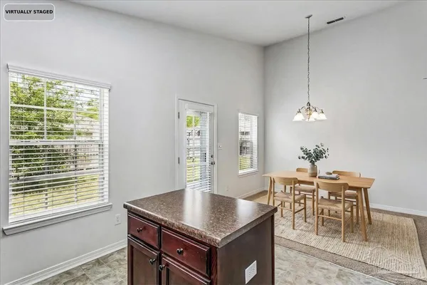 a view of a dining room with furniture and window