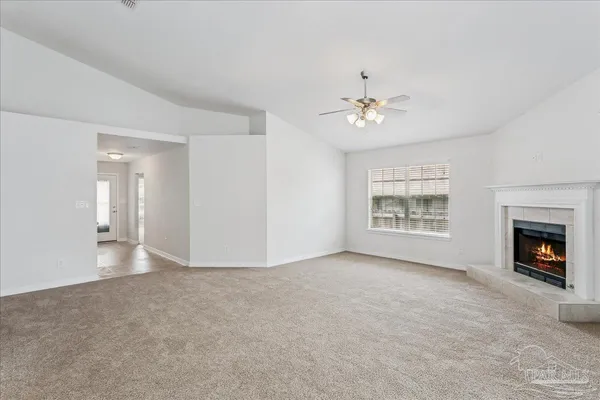 a view of an empty room with a fireplace