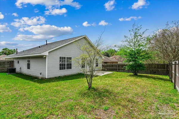 a view of a house with yard and a garden