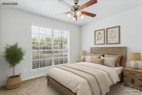 a bedroom with a large bed and a potted plant