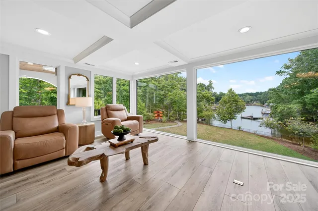 a view of a patio with a table chairs and a floor to ceiling window