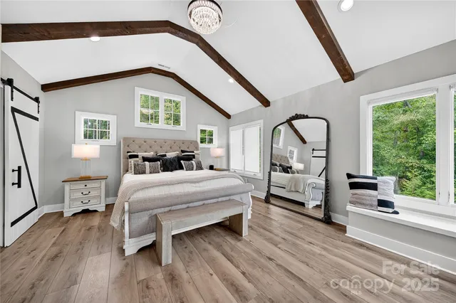 a view of a living room and window with wooden floor