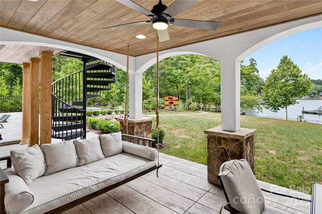 a view of a porch with furniture and garden